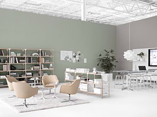 open plan office space. Left hand side with simple tan lounge chairs. Right side with a high top conference table and metal stools, tv on far right wall.