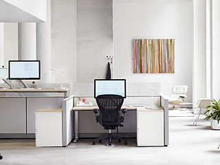 brightly lit office space. segmented desk space featuring the Herman Miller Aeron office chair in black.