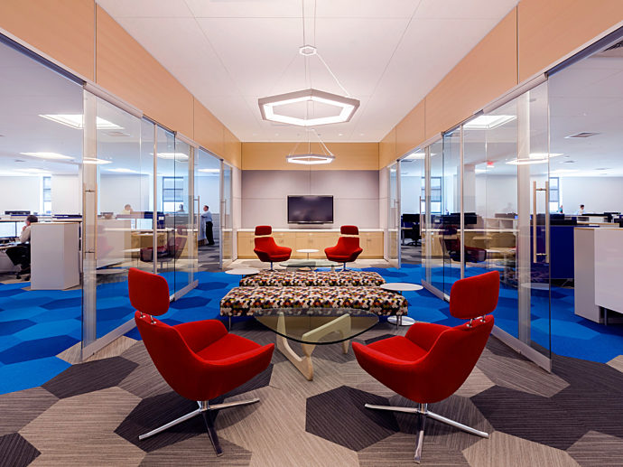 A corporate waiting area constructed using a prefabricated construction solution including glass walls, embedded technology & custom prefabricated ceiling