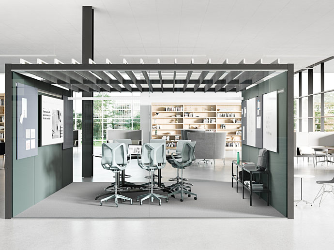interior office meeting area inside a larger office space. high top meeting table inside the meeting space, with Herman Miller Cosm Stools