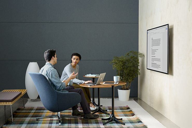 A small group setting with two people working