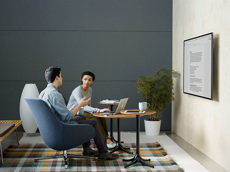 A small group setting with two people working